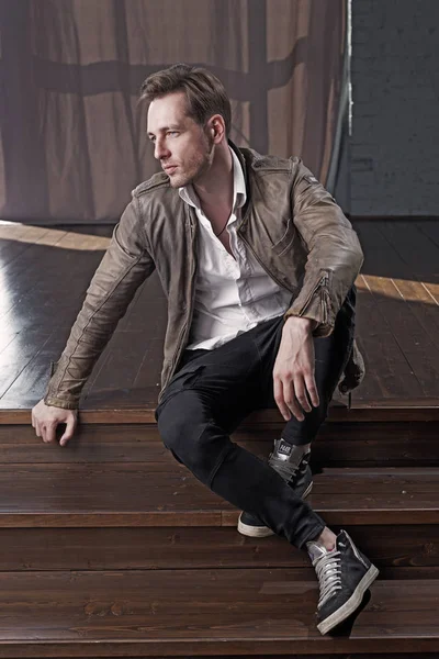Handsome male fashion model in leather jacket