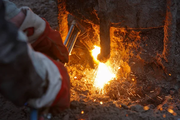 Welding machine with melting metal drops and sparks of sparks.