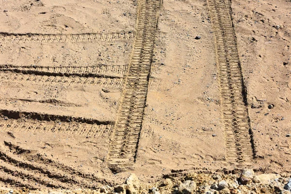Traces of tire treads on the sand.