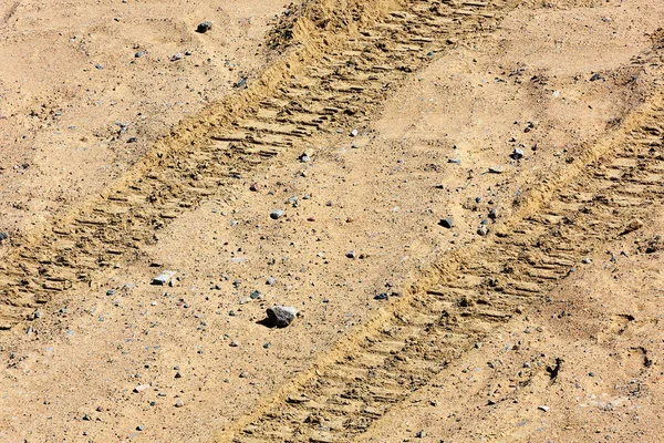 Traces of tire treads on the sand. Stock Photo