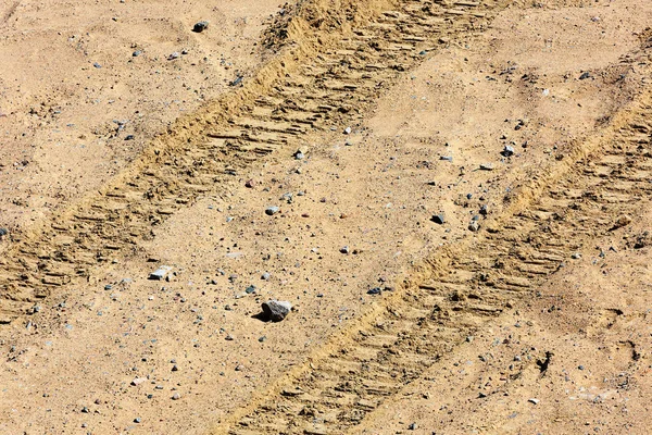 Traces of tire treads on the sand. Stock Picture