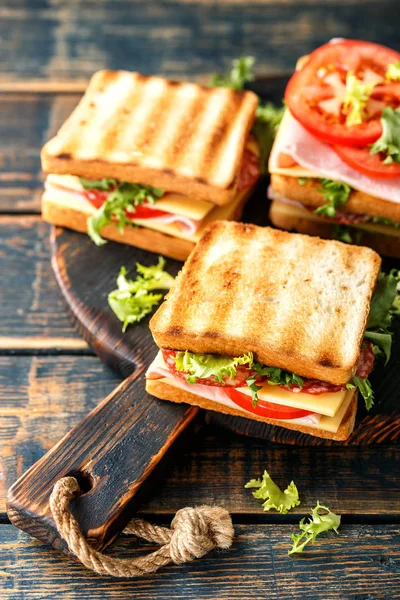 sandwiches with grilled toast ham salami cheese tomatoes and lettuce