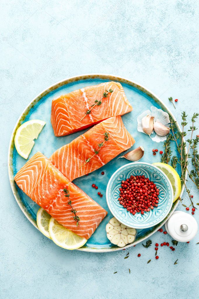 Seafood. Fresh raw salmon or trout fillets with ingredients, top view, space for a text