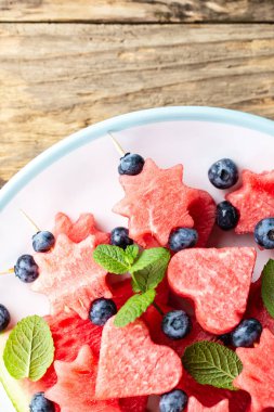 Kalpler ve yıldızlar şeklinde karpuz dilimleri. Gıda arka plan. metin alanı