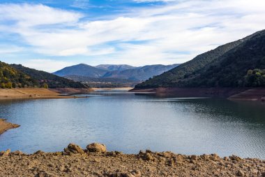 Arka plan olarak bulutlar ve dağ gökyüzü mavi karşı Ladonas yapay göl Arcadia, Yunanistan