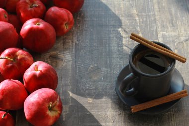 Kırmızı elma, kahve ve tarçın gri ahşap panoları veya masa üzerinde sopa. Yüksek açı, yakın çekim. Sonbahar, sonbahar, sabah, kahvaltı, sağlıklı gıda konsepti