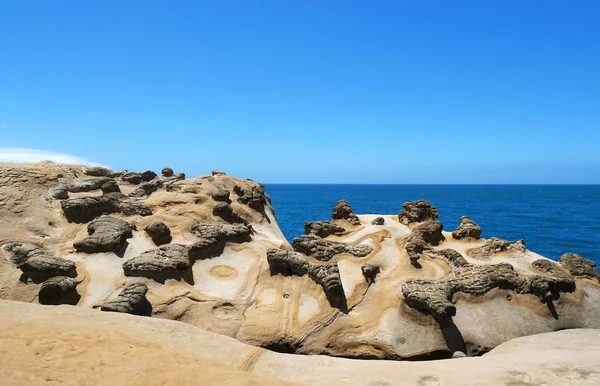Ginger rock landscape in Yehliu Geopark, New Taipei, Taiwan. The interlacing patterns as shown on the surface of ginger rock are the result of crust extrusion occurred underground.