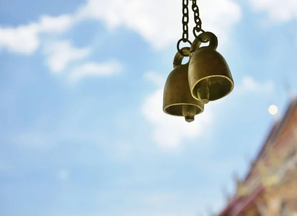 Close up of brass small bells in the temple background with copy space