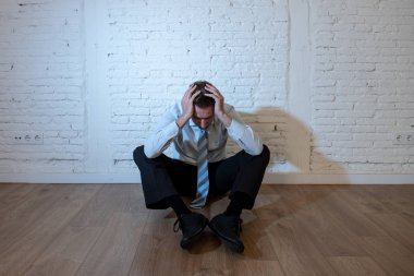 üzgün, yalnız ve ruh sağlığı depresyon kavramı içinde evde beyaz bir duvara yaslanmış anksiyete acı duygu depresif iş adamı