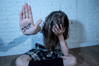 Genç Sevimli elinde yazılı metni durağı gösterilen liseli kızlar korkuyor. Çocuk istismar ve okul kavramı ve çocuk hakları zorbalık. Dramatik ışık