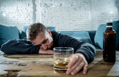 Sarhoş alkolik işsiz içme viski cam adam ve şişe alkol kötüye kullanımı ve alkolizm Konsept ev koltukta israf ve üzgün, depresif