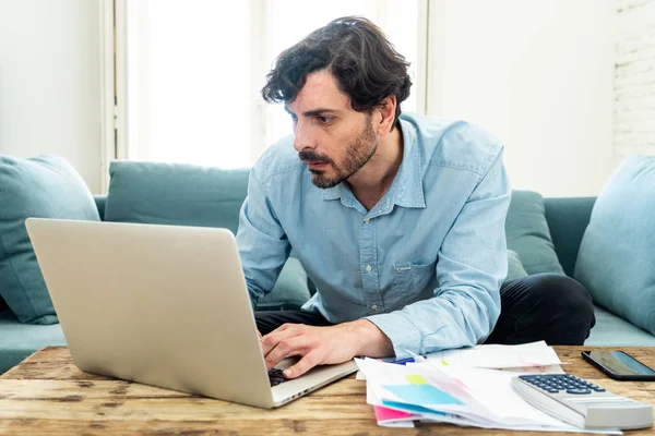 Laptop Ile Evde Çalışan Genç Sinirli Endişeli Erkeğin Faturaları Seyir — Stok fotoğraf