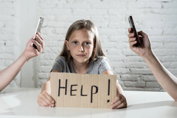 mother and father using mobile phones neglecting little sad ignored daughter bored and lonely feeling abandoned and disappointed with  parents.  mobile cell smart phone addiction bad behavior concept