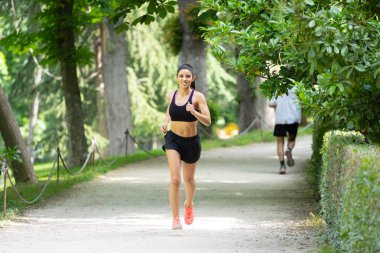 çalışan ve ağaçlar ve sarı yapraklar Şehir Park açık havada koşu eğitim sonbahar spor giyim kadın genç çekici ve mutlu atlet. Fitness ve sağlıklı yaşam konsepti