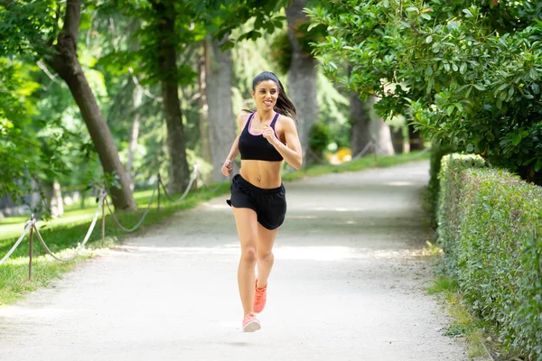 çalışan ve ağaçlar ve sarı yapraklar Şehir Park açık havada koşu eğitim sonbahar spor giyim kadın genç çekici ve mutlu atlet. Fitness ve sağlıklı yaşam konsepti