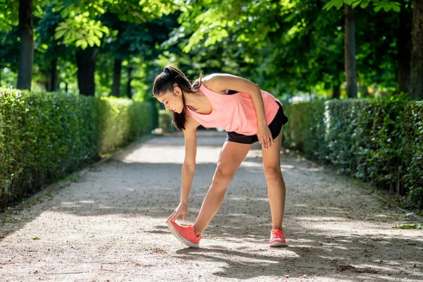 Daha önce fitness antrenman fitness sağlık kavramı vücudu germe içinde açık havada kadar ısınma Gölü sağlıklı genç bir kadın ile parkta genç çekici latin kadın egzersiz.