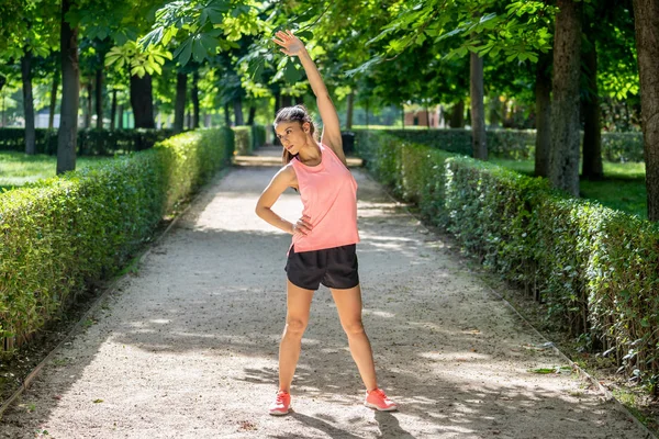 Daha önce fitness antrenman fitness sağlık kavramı vücudu germe içinde açık havada kadar ısınma Gölü sağlıklı genç bir kadın ile parkta genç çekici latin kadın egzersiz.