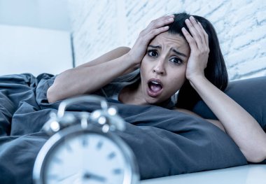 Genç güzel İspanyol kadın evde yatak odası acı uykusuzluk uyku bozukluğu uyumaya çalışıyor geceleri yatakta yatan ya da kabuslar üzülmüş korkmuş ruh sağlığı kavramı endişeli