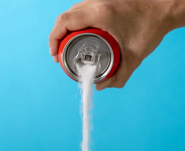 Hand holding a soda can pouring sugar — Stock Photo, Image