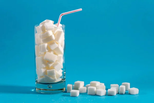 Glass with straw with sugar cubes — Stock Photo, Image