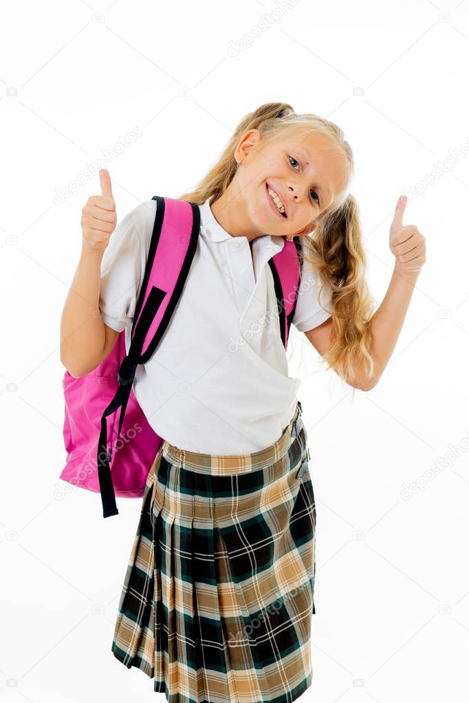 Pretty cute blonde hair girl with a pink schoolbag looking at camera showing thumbs up gesture happy to go to school isolated on white background in back to school and children education concept