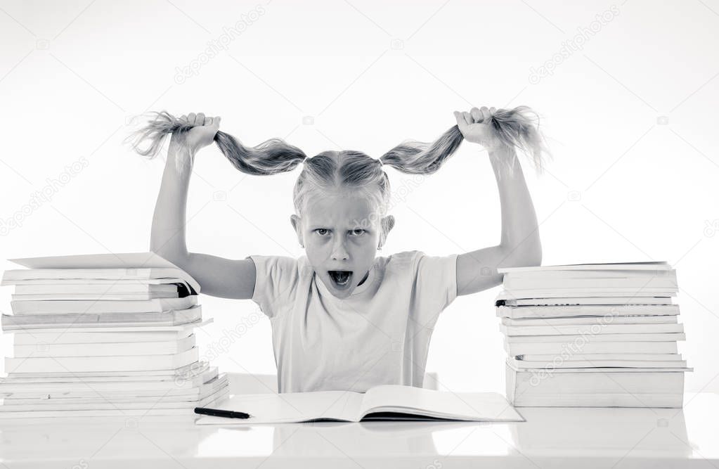 Beautiful school girl trying to study. Having too many homework that It's driving her crazy. Children education concept isolated on white background