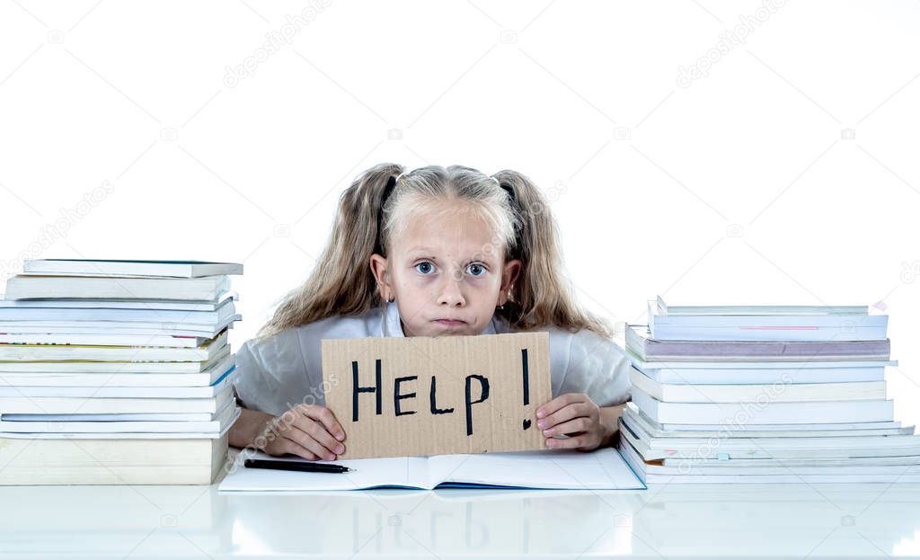 Frustrated little schoolgirl feeling a failure unable to concentrate in reading and writing. Learning problem and low academic performance concept