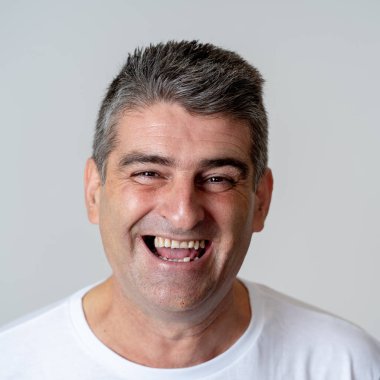 Yakın çekim portre çekici bir orta yaşlı eğlenmek ve mutlu neşeli gülümseyen ve gülerek bakıyor adam kamera insan duyguları yüz ifadeleri mutluluk ve duygular