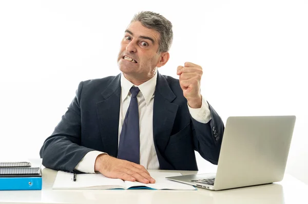 Angry and desperate businessman shouting with laptop computer and paperwork in business people stress fail and technology concept isolated in white background.