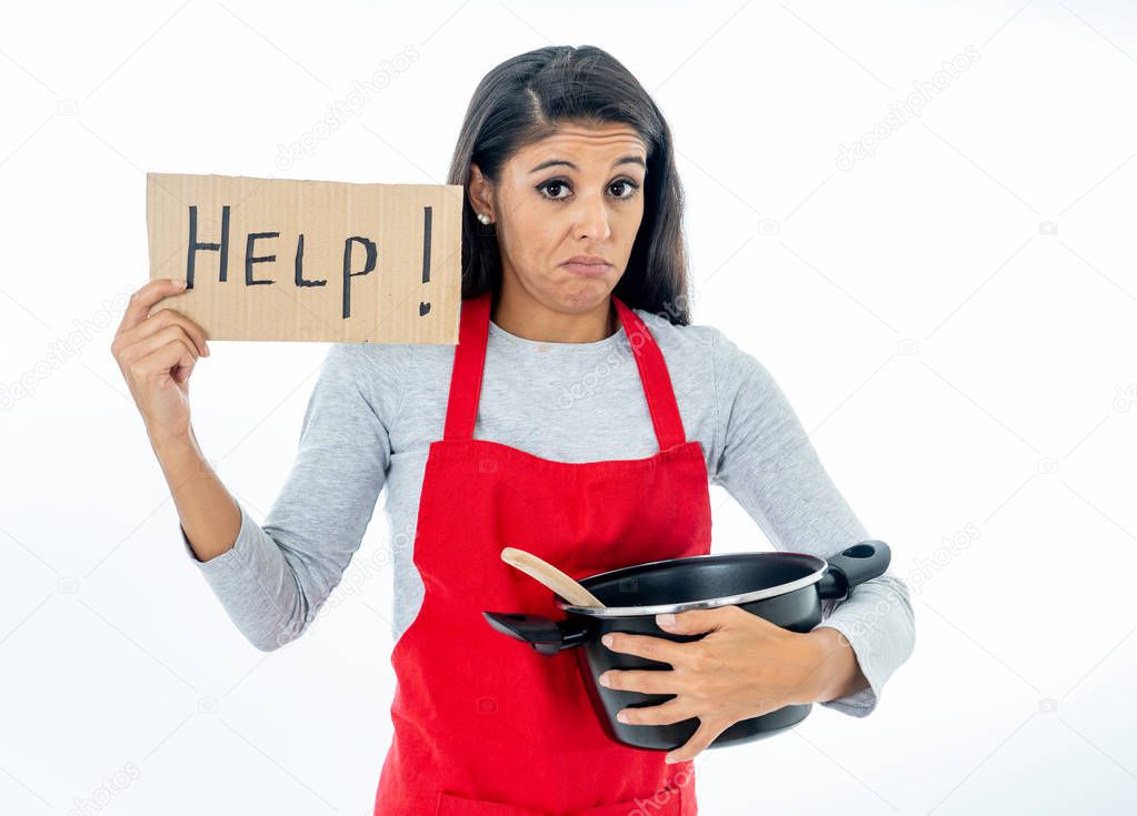 Portrait of desperate helpless inexperienced home cook woman asking for help wearing red apron learning to cook in cooking classes isolated on white background.