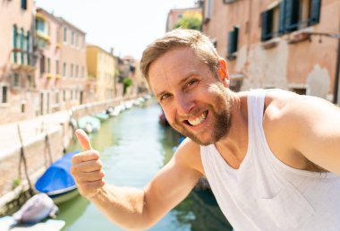 Genç çekici t beyaz sarışın turist eğleniyor tatilde İtalya'da Europe yaz seyahat tatil kavramı içinde Venedik Canal selfie alarak.