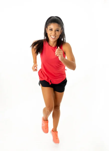 Young attractive happy latin woman in sport clothes with beautiful smile running and training on jogging workout isolated on white background in fitness healthy lifestyle concept.