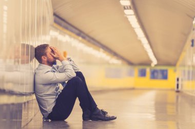 Genç işsiz iş adam oturan depresyon acı duvar yalnız duygusal acı ruh sağlığı işsizlik ve insan duyguları kavramı umutsuz seyir üzerinde Sokak Metro yaslanmış zemin.
