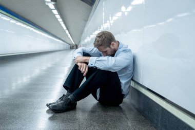 Umutsuz üzgün genç işadamı duygusal acı keder ve depresyon ve stres yaşam tarzı çalışma sorunları başarısızlık işsizlik ruh sağlığı tünel Metro tek başına oturan derin depresyon acı.
