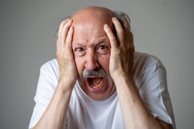 Close up portrait of a scared frightened old man in expression of fear in human emotions and facial expressions isolated in neutral background. clipart
