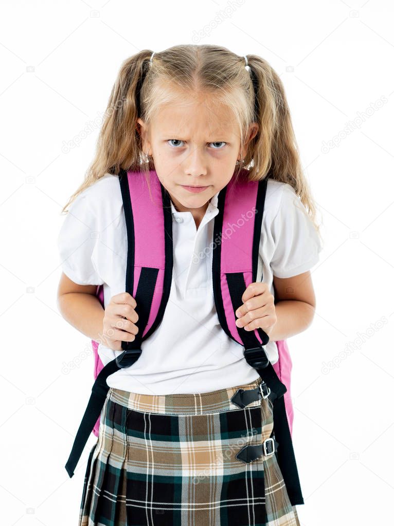 Sweet beautiful little girl in school uniform feeling angry and frustrated looking at the camera isolated on white background in homework learning difficulties back to school and education concept.