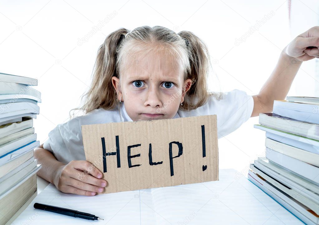 Angry little girl with a negative attitude towards studies and school after studying too much and having too many homework in children education concept isolated on a white background