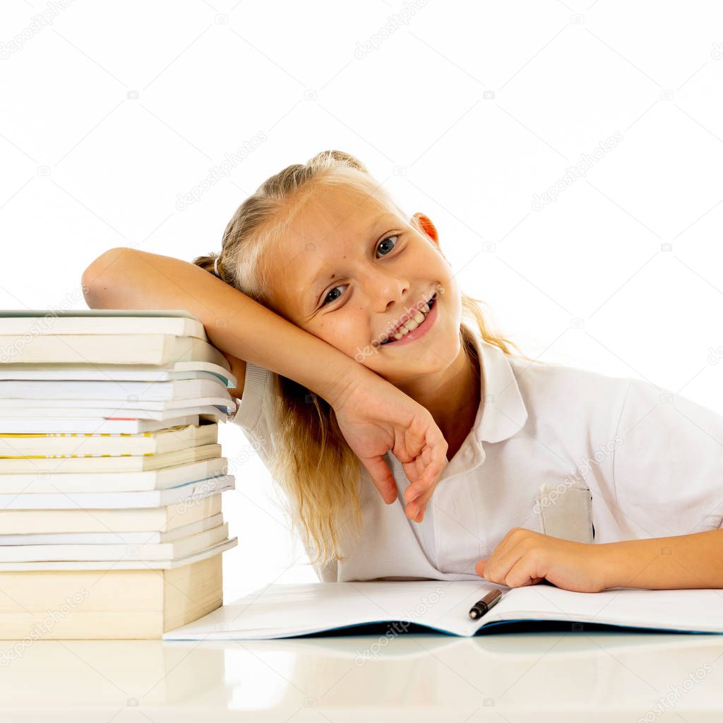 Happy beautiful cute with blond hair little schoolgirl likes studying and reading books in creative education concept with Back to school theme isolated on white background.