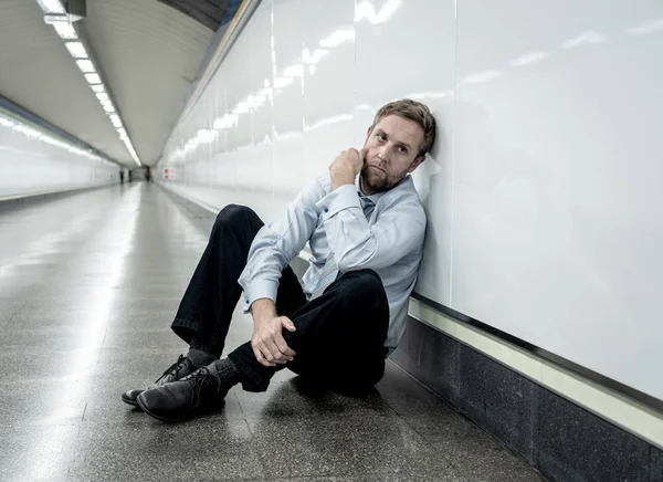 Desperate sad young businessman suffering emotional pain grief and deep depression sitting alone in tunnel subway in Stress life style Work problems failure Unemployment Mental health and Depression.