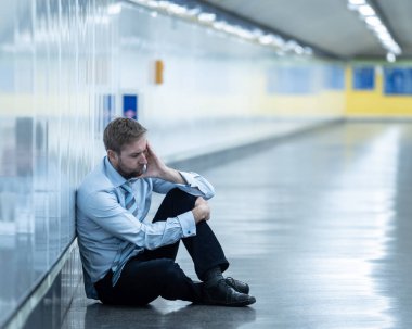 Genç işsiz iş adam oturan depresyon acı duvar yalnız duygusal acı ruh sağlığı işsizlik ve insan duyguları kavramı umutsuz seyir üzerinde Sokak Metro yaslanmış zemin.