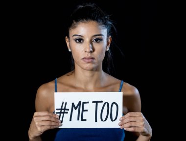 Me Too Harassment Campaign. Portrait of young woman holding a note with the text me too in social movement stop sexual abuse women human rights concept isolated on black background. clipart
