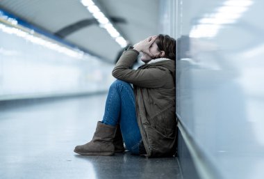 Genç Yetişkin utanç felling depresif ve umutsuz tek başına oturmak içinde depresyon yalnızlık ruh sağlığı zemin Metro City duygusal ağrı sosyal şiddet edici ilişki ve taciz kavramı.