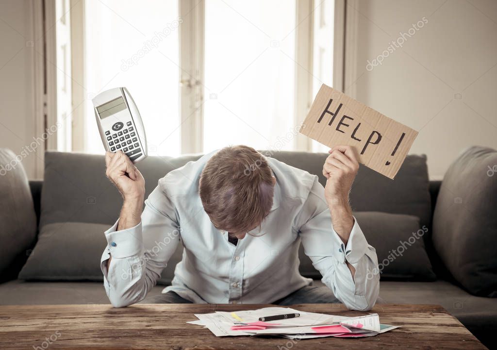 Worried and desperate business man asking for help in paying off debts and loan calculating bills tax expenses and accounting finances sitting on couch in paying bills and Financial problems concept.