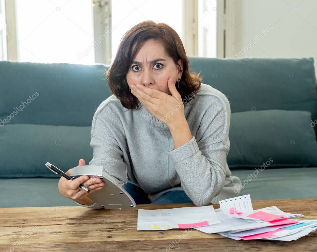 Young attractive woman looking stressed and worried with card payments and home finances accounting costs charges taxes and mortgage in paying bills financial problems and credit card debts concept.