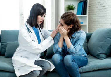 Ağlayan kadın hasta hastane özel ofisinde hastalığı teşhis veya kötü haber sağlık hizmetlerinde destek ve güven kavramı ciddi dinledikten sonra harap oturan kadın doktor rahatlatıcı depresif.