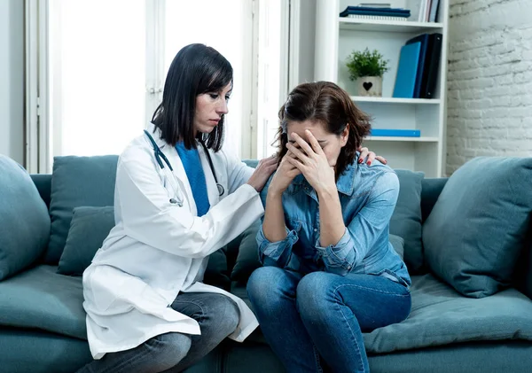 Female doctor comforting depressed crying woman patient sitting devastated at hospital private office after hearing serious disease diagnose or bad news in Health care support and trust concept.