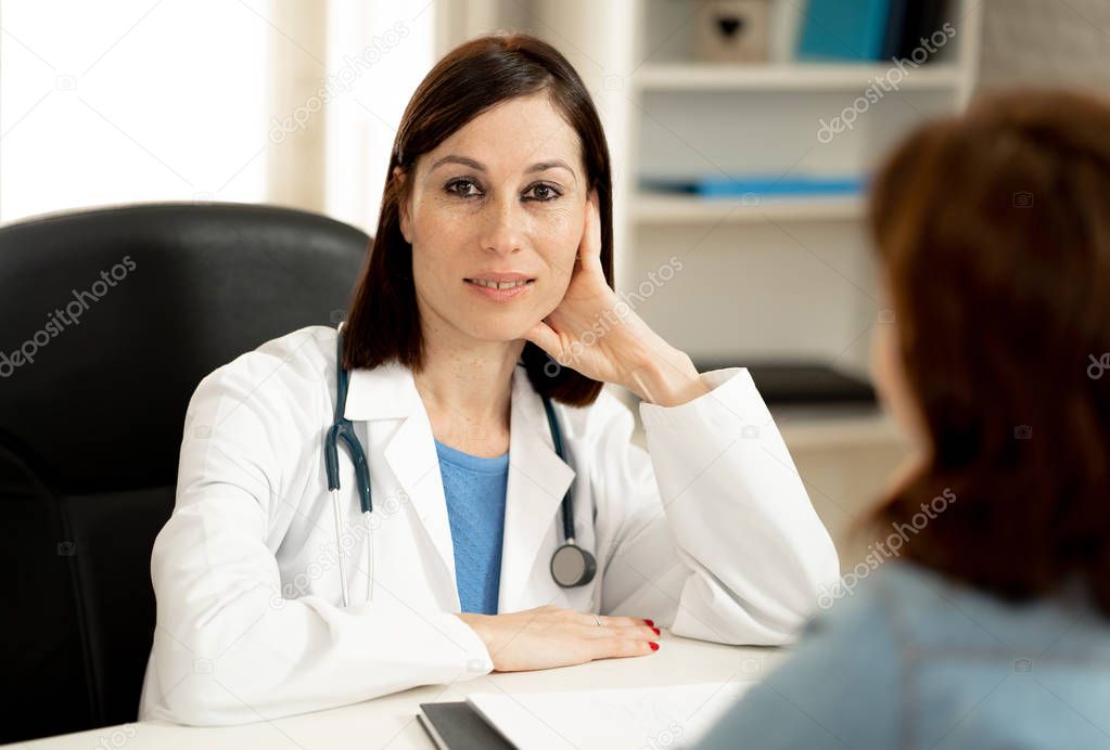 Smiling female doctor and happy patient talking and consulting in hospital clinic office in Health care, professional medical staff, happy hospital environment, Insurance and Medical trust concept.