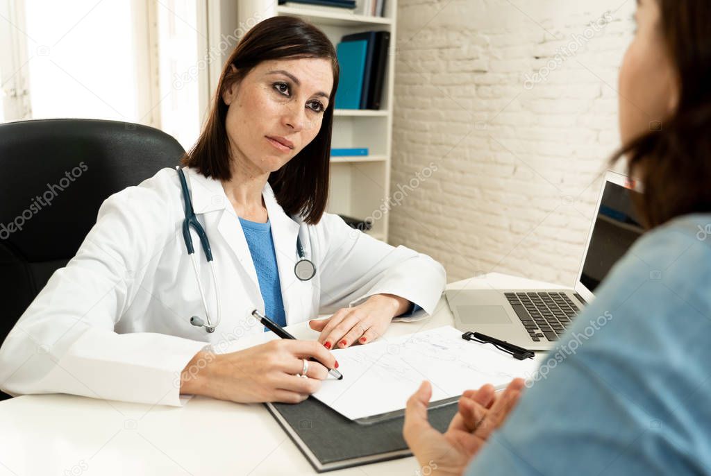 Female family doctor listening carefully to woman patient problems and symptoms in partnership, health care and medical treatment psychiatry communication and trust concept.