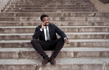 Akıllı cep telefonunda kentsel merdiven sokak şehir dışında mutlu konuşurken çekici iş adamı. İnsanlar, sosyal ağ, özgürlük, modern teknoloji ve girişimci yaratıcı iş kavramı.