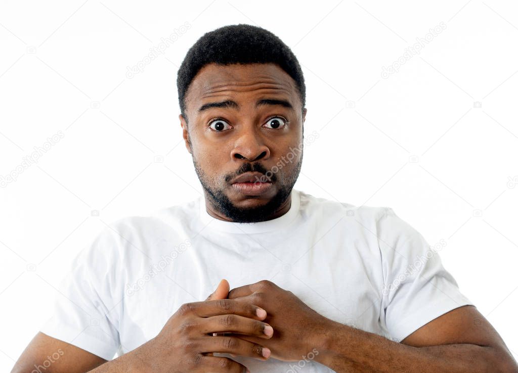 Portrait of Handsome young man in shock with a scared expression on his face making frightened and defending gestures in human emotions feelings and facial expression. Isolated on grey background.